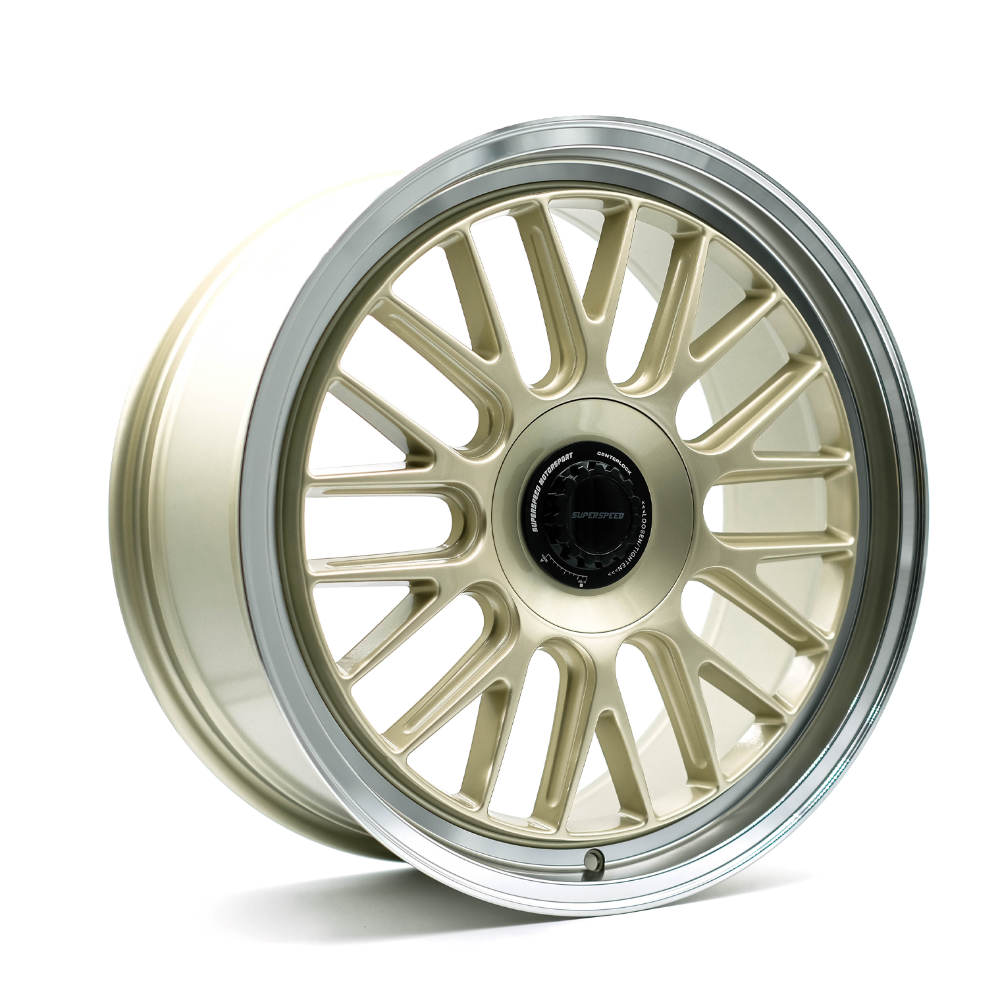 Gold alloy wheel on a white background